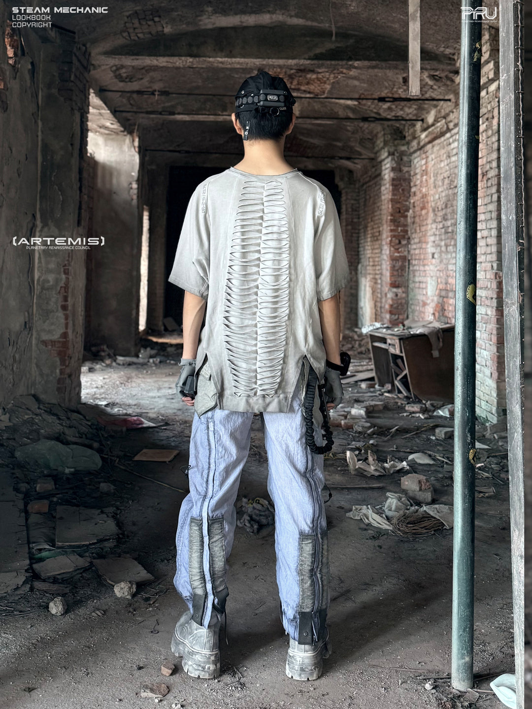 ERODED SPINE distressed asymmetric tee in oxidized white — full-length back modeled view