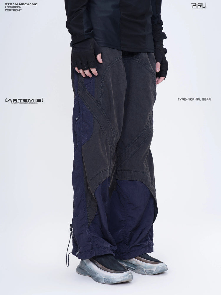 SUPERNOVA zima blue metallic nylon technical pants — three-quarter front modeled close-up facing right