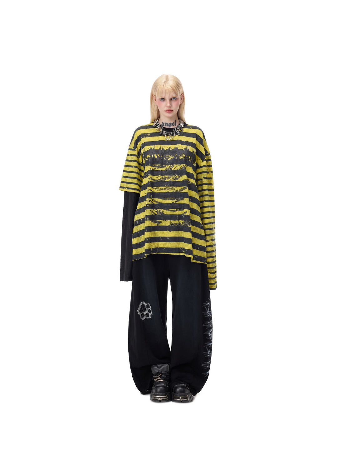 PINKSPINK STATIC asymmetric striped burnout long-sleeve tee in black and yellow — centered full-length front modeled pose over separate black trousers, also used in the fixed gallery