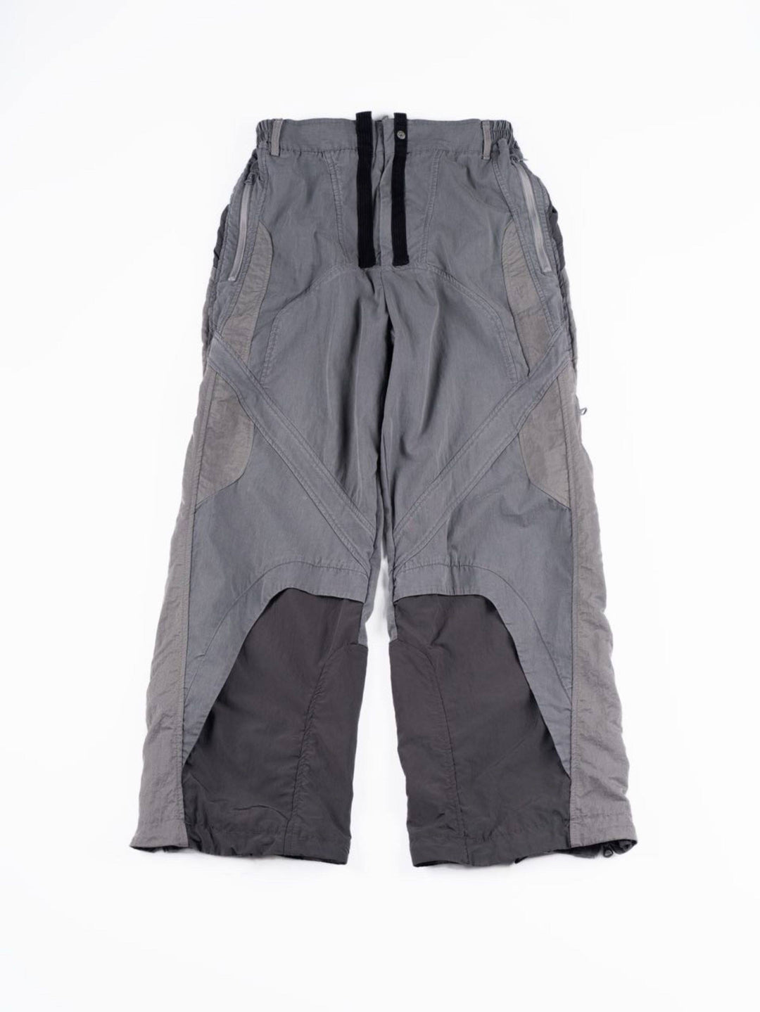 SUPERNOVA alloy gray metallic nylon technical pants — alloy gray front flat-lay showing curved panels and zip pockets