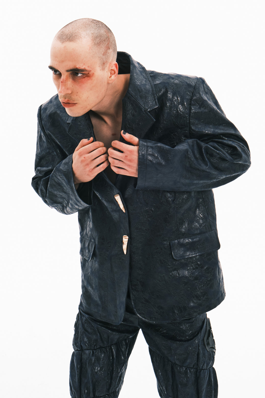 EMBRYO HORN CODE textured PU leather blazer — close modeled styling view
