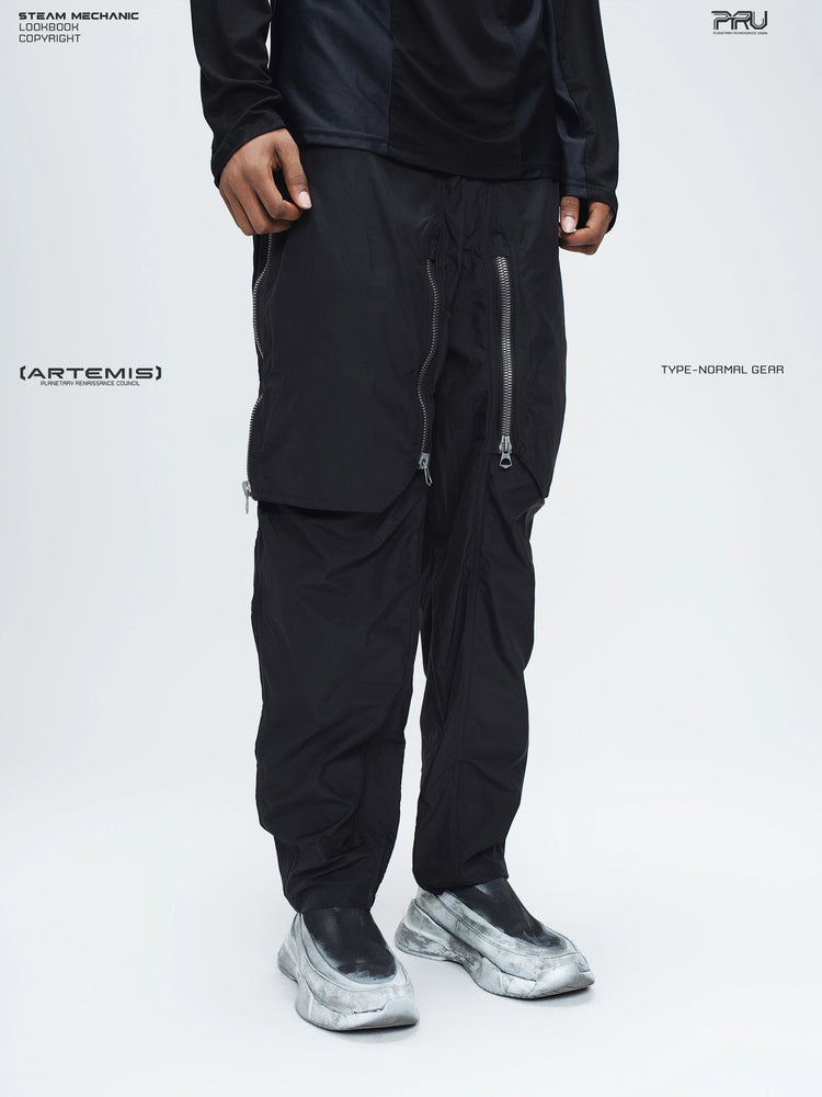 GAIA black curved-blade technical pants — three-quarter front modeled view of the curved front panels