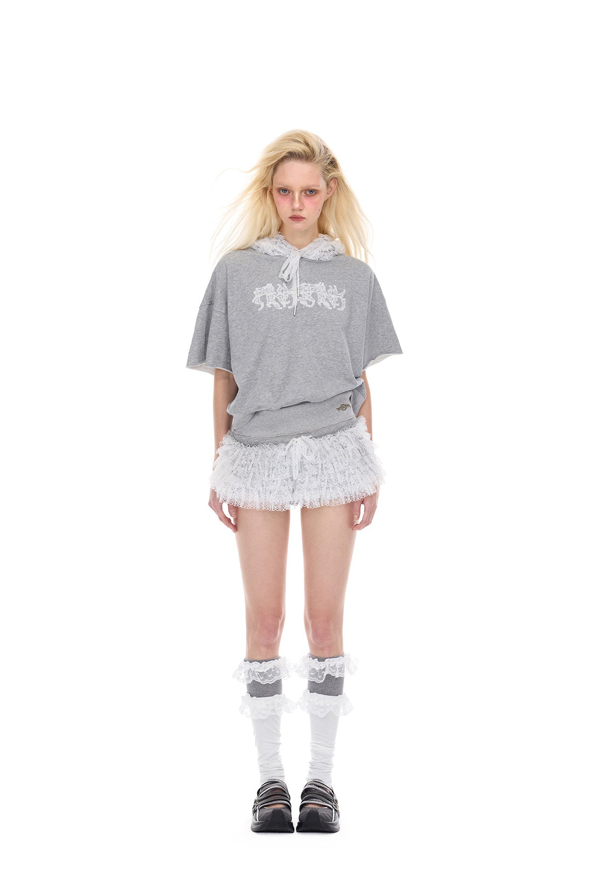 PINKSPINK MULTIVERSE lace micro shorts skirt — close modeled view highlighting the construction