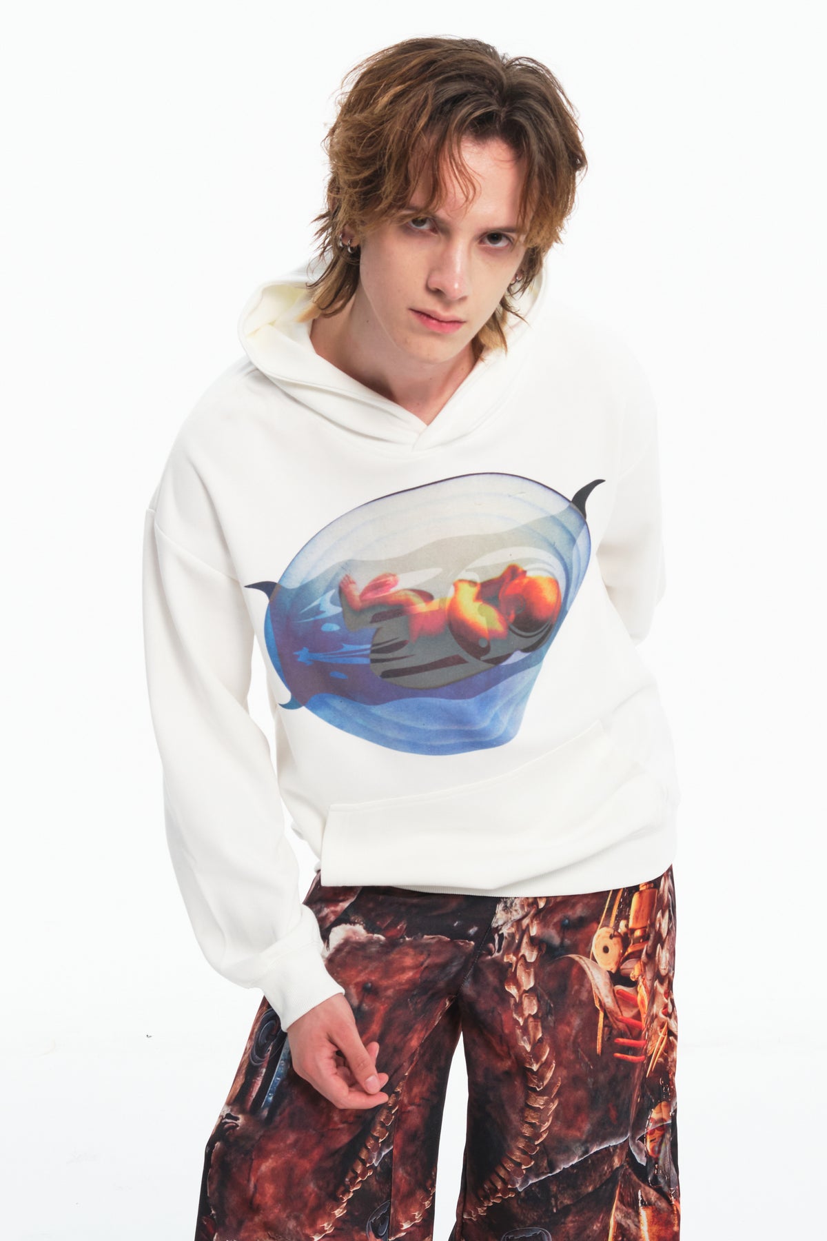 EMBRYO PLAN white graphic hoodie — leaning front modeled close-up showing the capsule graphic