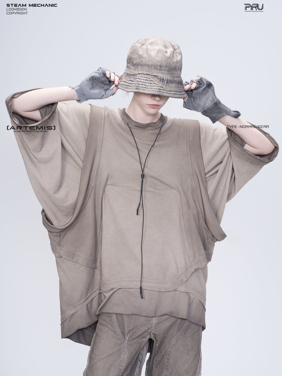 PIONEER mercury brown distressed nylon bucket hat — modeled view with both hands holding the brim