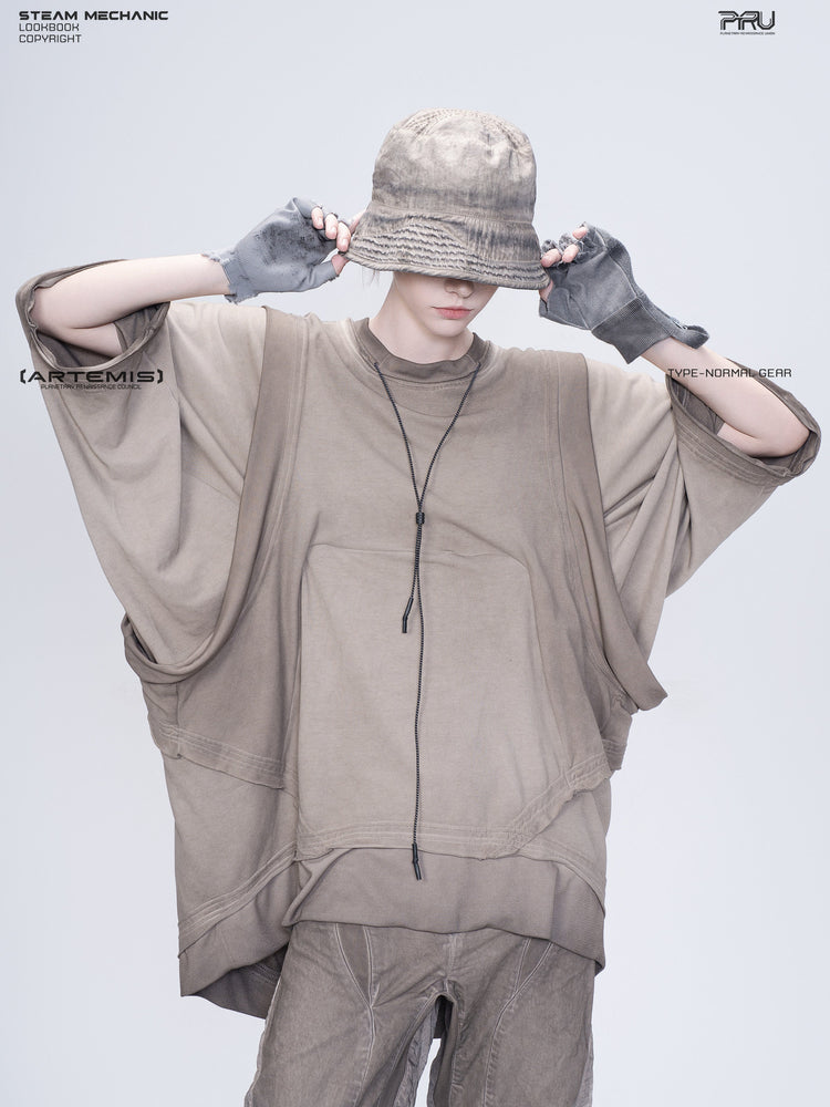 PIONEER mercury brown distressed nylon bucket hat — modeled view with both hands holding the brim