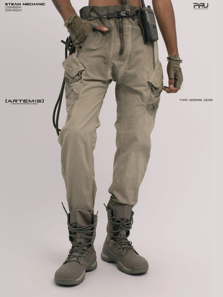 AEGIS lunar soil teal multi-pocket moto pants — front angled modeled view with a hand in the pocket