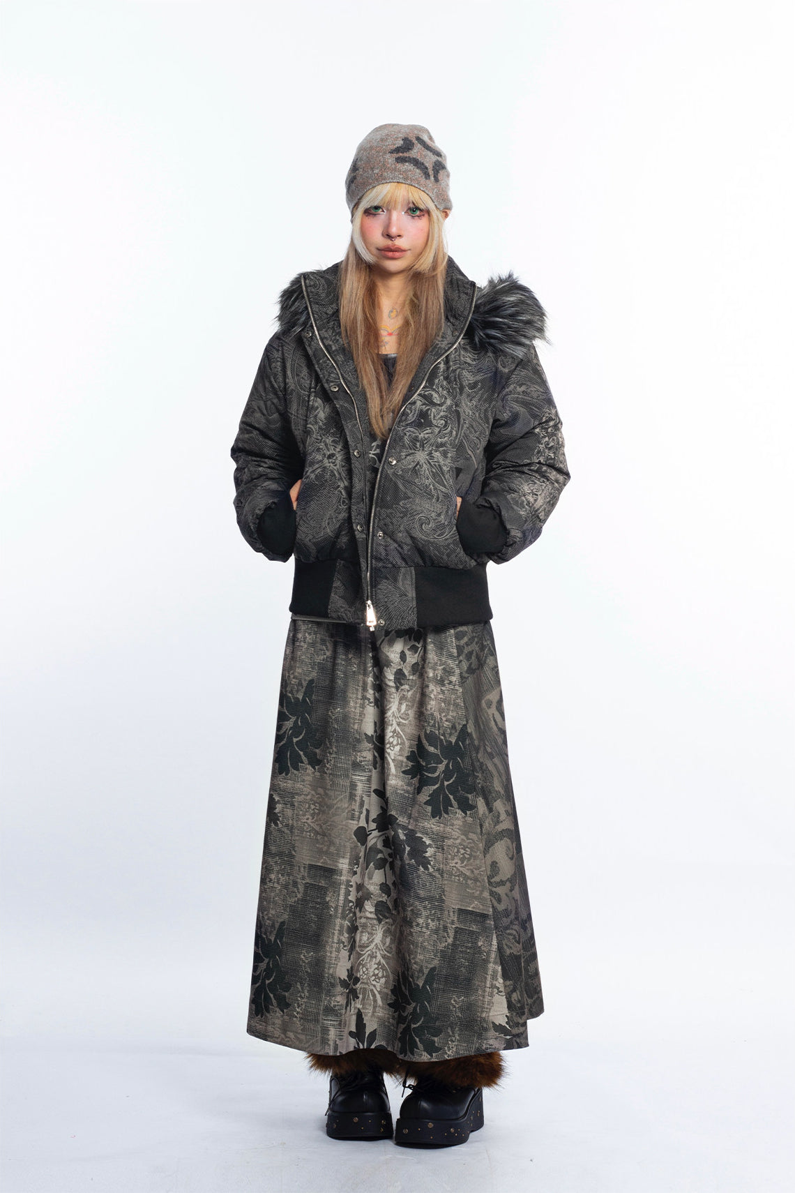 4RE1GN GOTHIC down jacket in charcoal ornamental print — Full-body front view styled with a long skirt and beanie.