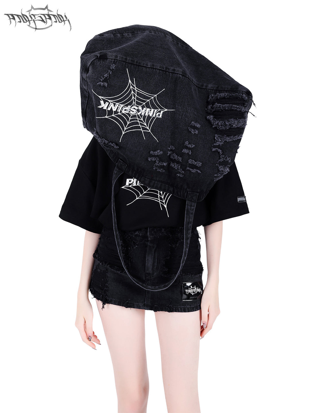 PINKSPINK SPIDER distressed denim shoulder tote — front modeled view with the oversized tote held above the shoulders