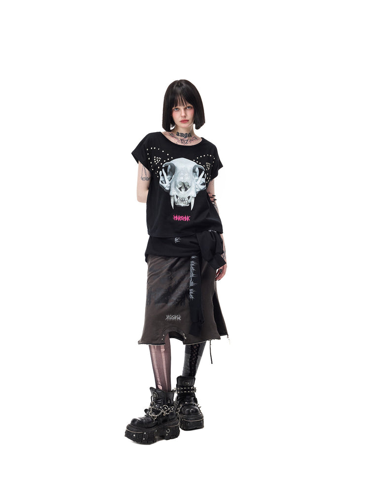 PINKSPINK CATACOMB reversible cat-skull tee in black — angled cat-skull-face view with hand behind, styled with a separate long skirt