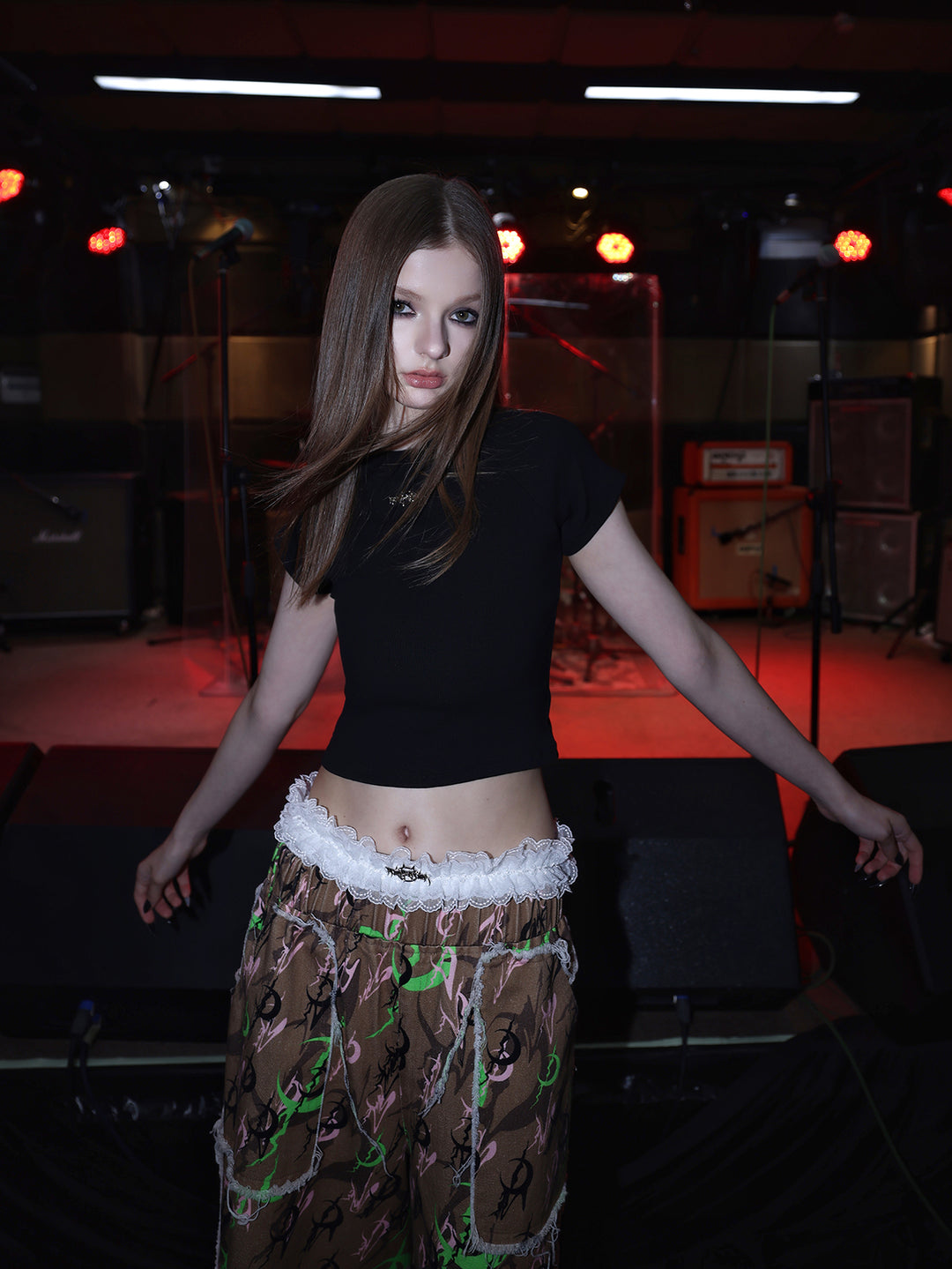 PINKSPINK ELECTRIC MOON distressed camo cropped trousers in CAMOUFLAGE — close front with arms extended.