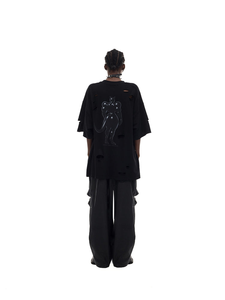 PINKSPINK FUTURE CAT distressed oversized tee in black — rear full-length modeled view styled loosely with trousers