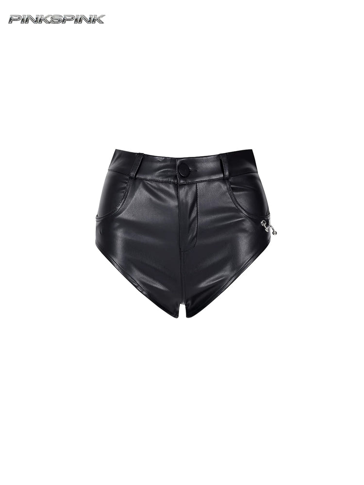 PINKSPINK REBEL ring-pierced faux-leather hotpants in black — front garment-only view showing the curved leg opening and ring detail