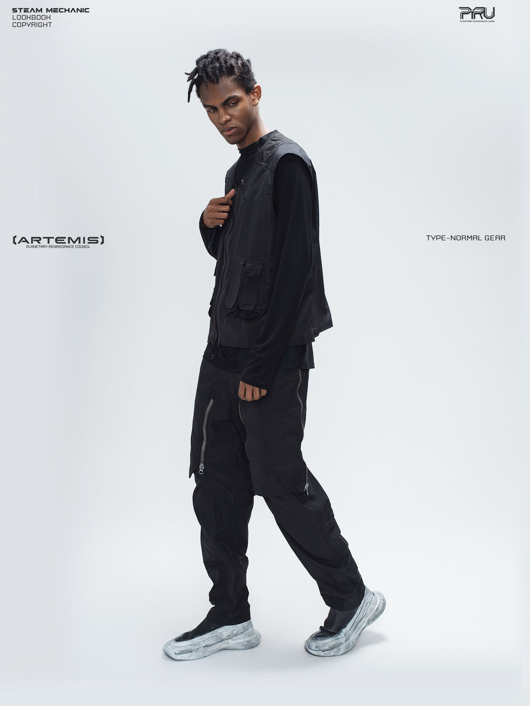 GAIA curved-blade technical pants in black — full-length side styling view showing the tapered leg