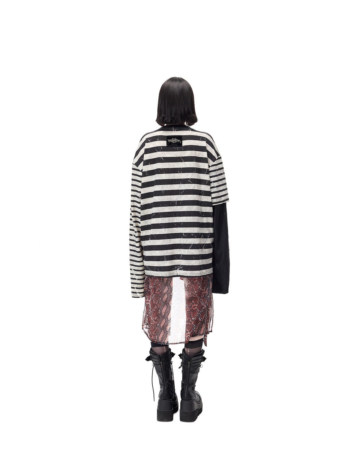 PINKSPINK STATIC asymmetric striped burnout long-sleeve tee in black and white — full-length rear modeled view showing the stripes and upper-back brand patch