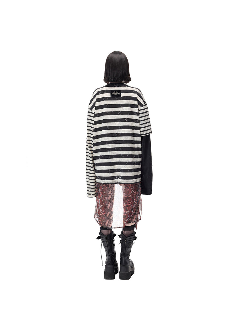 PINKSPINK STATIC asymmetric striped burnout long-sleeve tee in black and white — full-length rear modeled view showing the stripes and upper-back brand patch