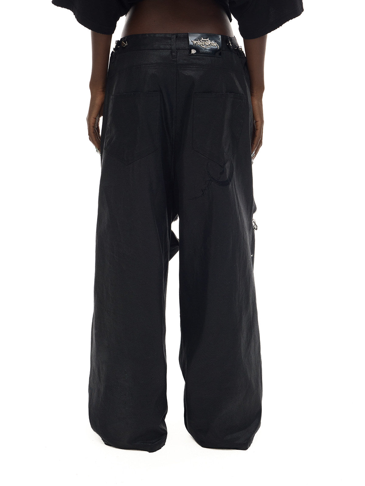 PINKSPINK ELECTRIC MOON coated zip-knee wide-leg pants in black — rear waist-to-hem modeled view showing the pockets