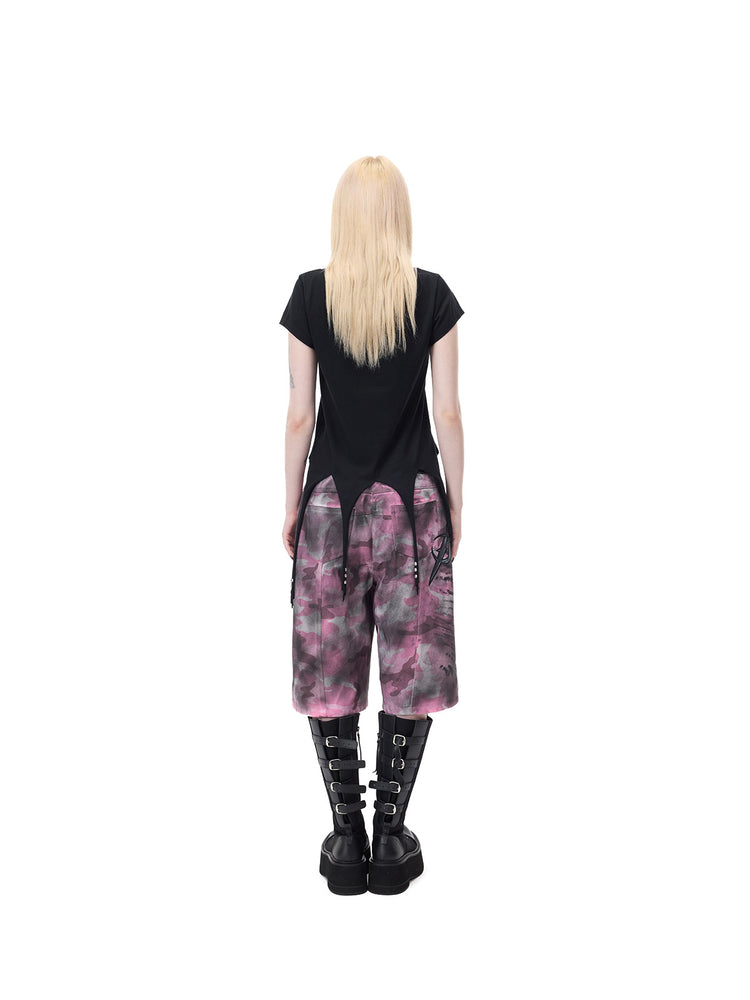PINKSPINK PUNK CACTUS studded pointed-hem tee in black — full-length rear modeled view with the tee worn over separate pink camouflage shorts