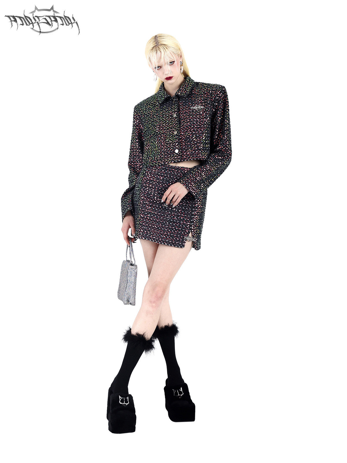 PINKSPINK SPARK sequined jacket and mini skirt set — black sequined set, three-quarter view with crossed legs