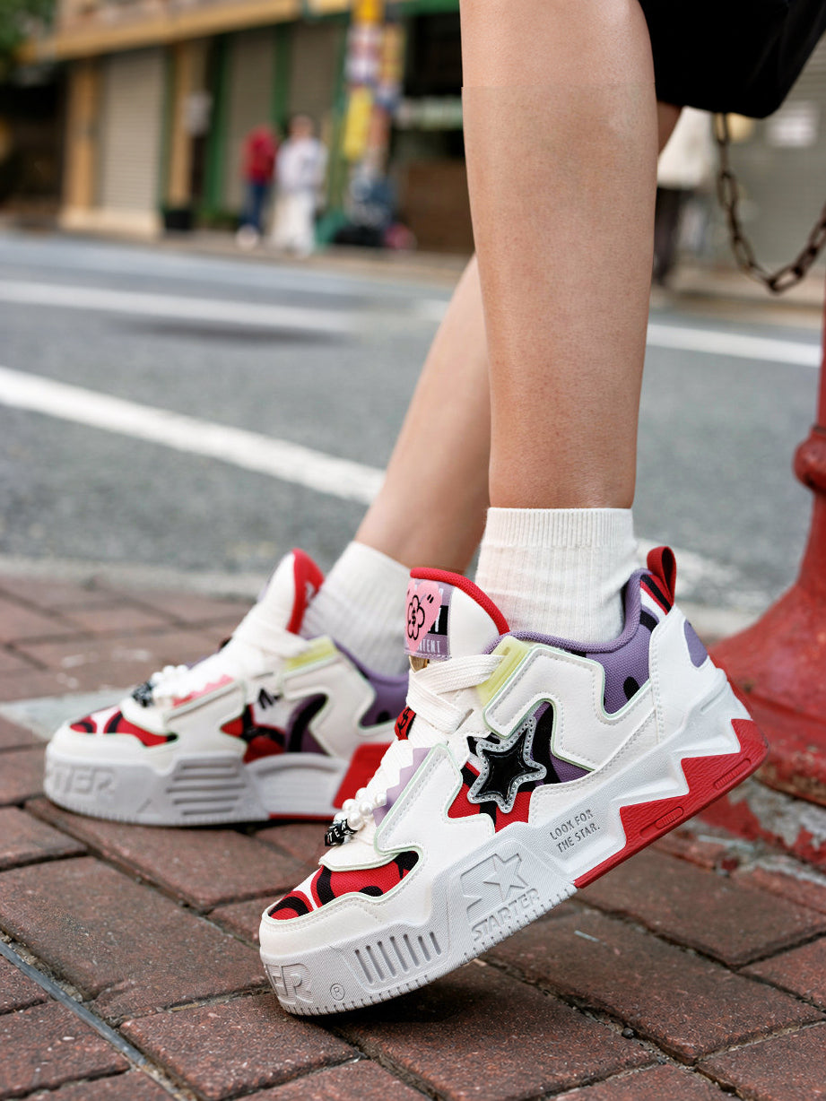 STARTER RICHFLOWER Fortune Red sneakers beside a street hydrant, side view of the white star panels and red soles