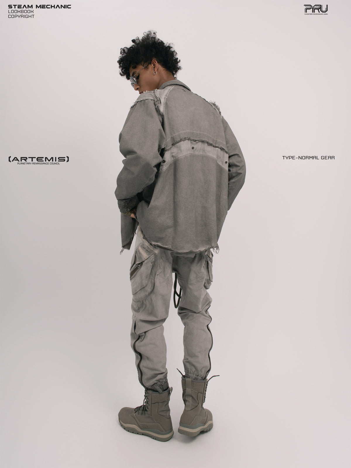 CHAOS ERA moon dust gray raw-edge technical shirt — three-quarter rear modeled view showing raw-edge panels