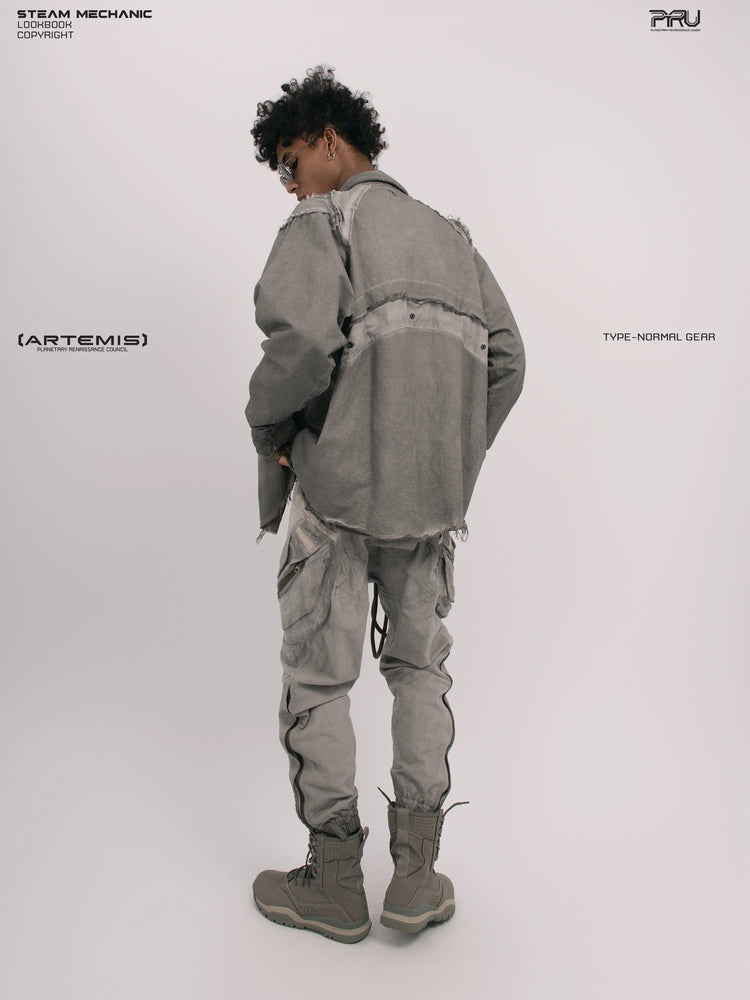 CHAOS ERA moon dust gray raw-edge technical shirt — three-quarter rear modeled view showing raw-edge panels