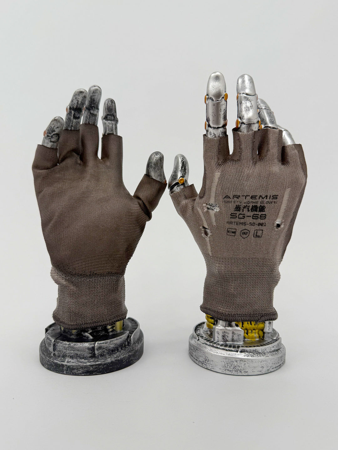 PRECISION CASTING distressed fingerless gloves in brown soil, PALM GLUE — coated palm and ARTEMIS-printed back views on display hands