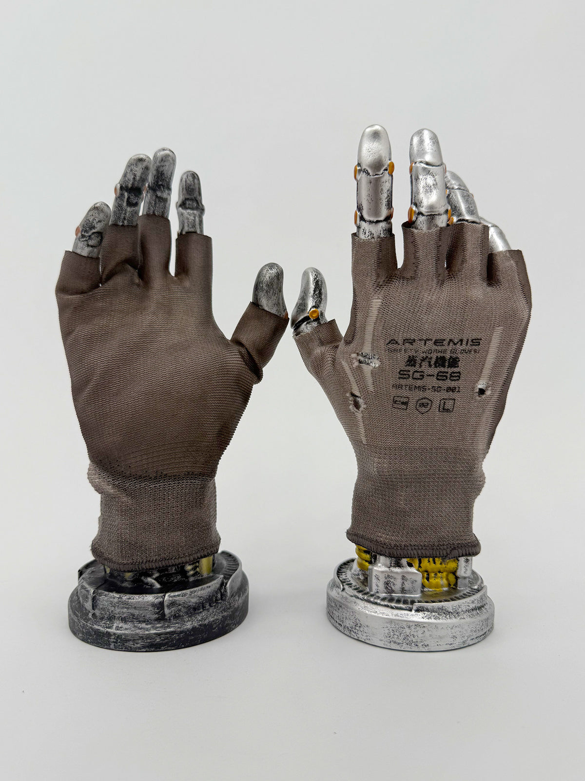 STEAM FUNCTION PRECISION CASTING distressed fingerless gloves in brown soil, PALM GLUE — coated palm and ARTEMIS-printed back views on display hands