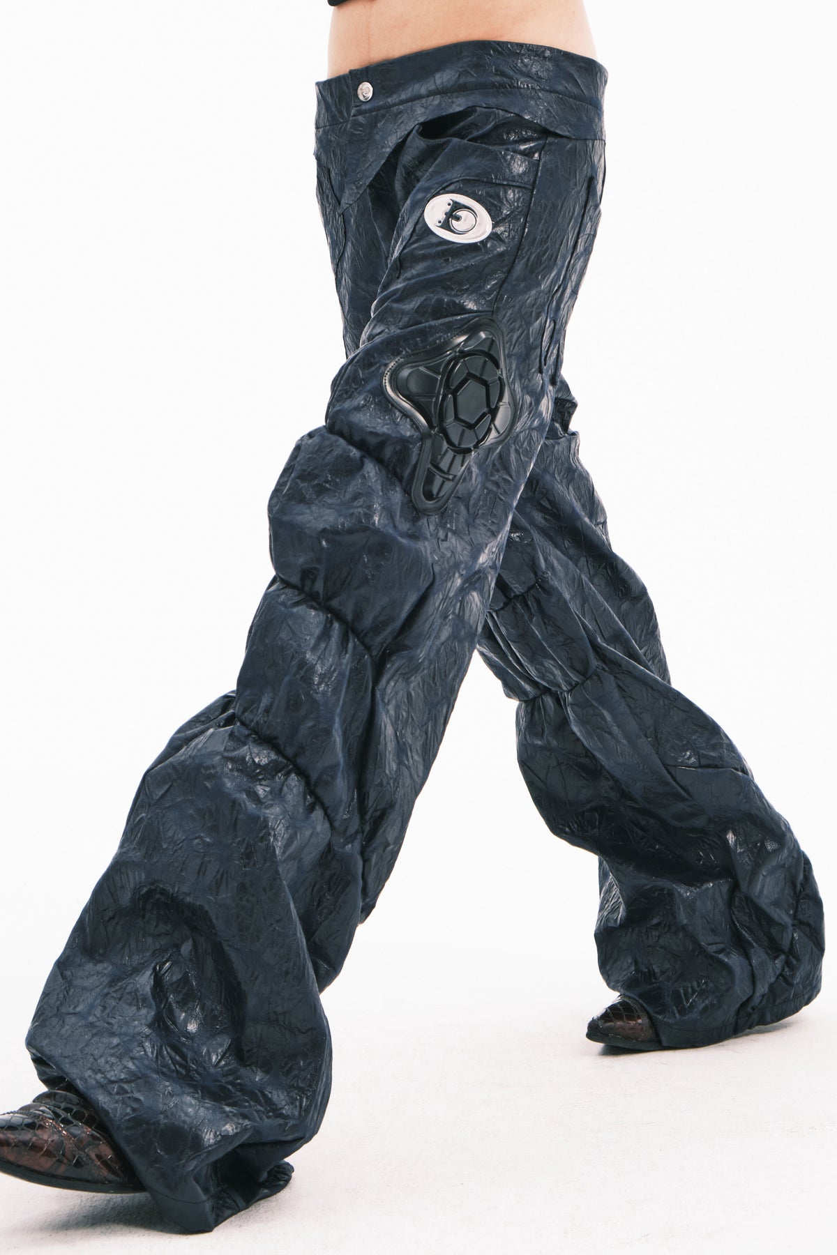 EMBRYO GUARD SHELL ruched PU leather flare pants — construction and silhouette detail