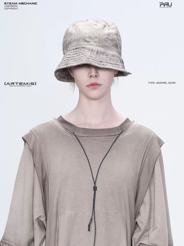 PIONEER mercury brown distressed nylon bucket hat — front portrait showing the distressed bucket crown and stitched brim