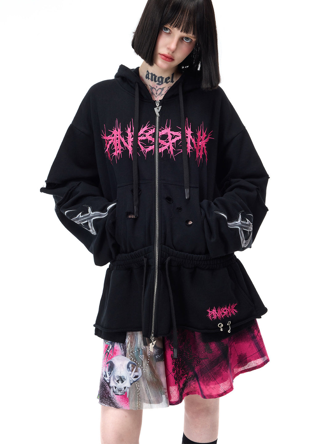 PINKSPINK FUTURE PORTRAIT reversible graphic mini skirt in black and pink — close outfit view of the portrait panel beneath a separate black zip-up hoodie