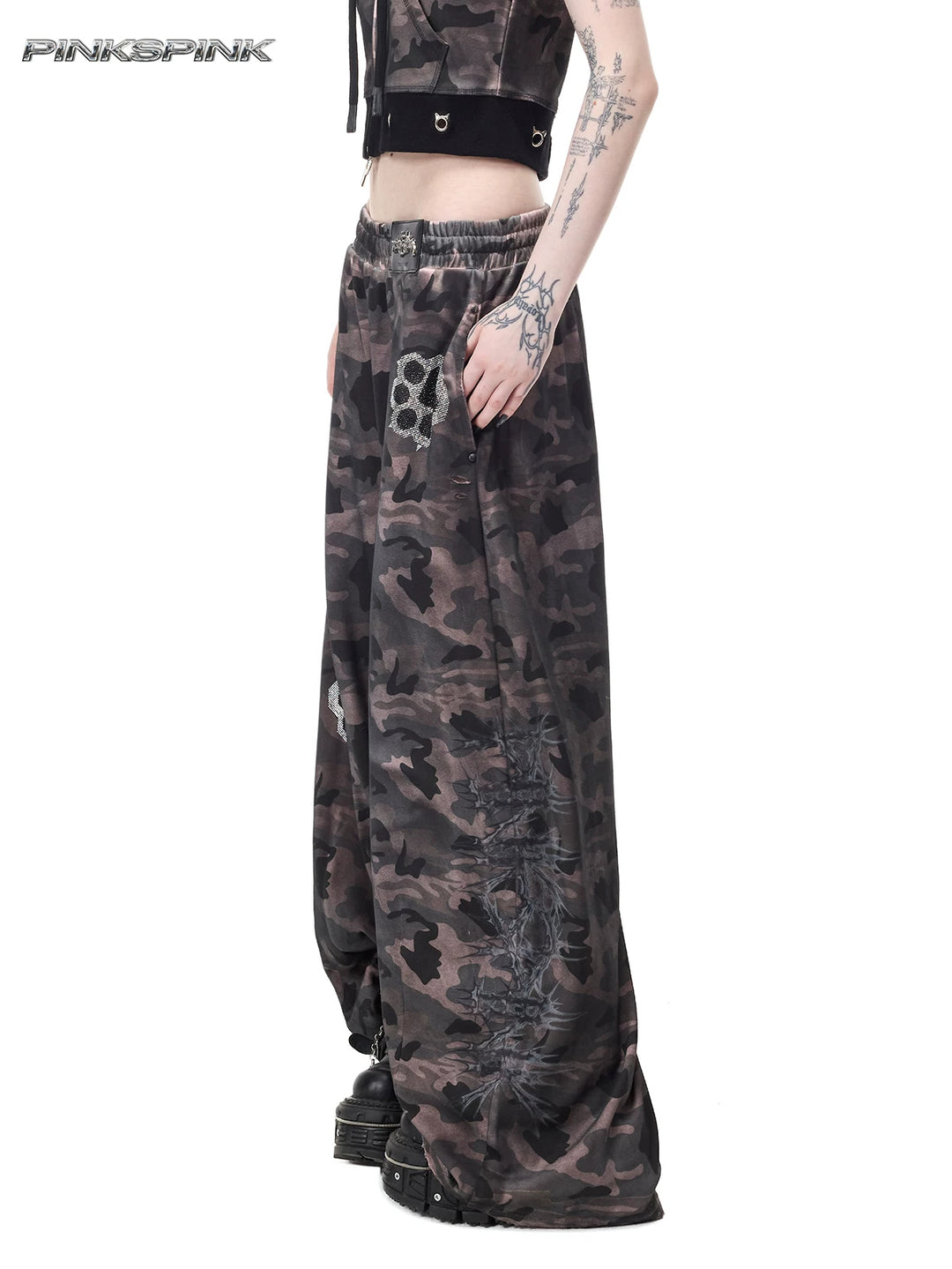PINKSPINK CATPAW rhinestone curved-leg sweatpants in gray-brown camouflage — close angled front modeled view showing the elastic waist, paw motifs and thorn graphic