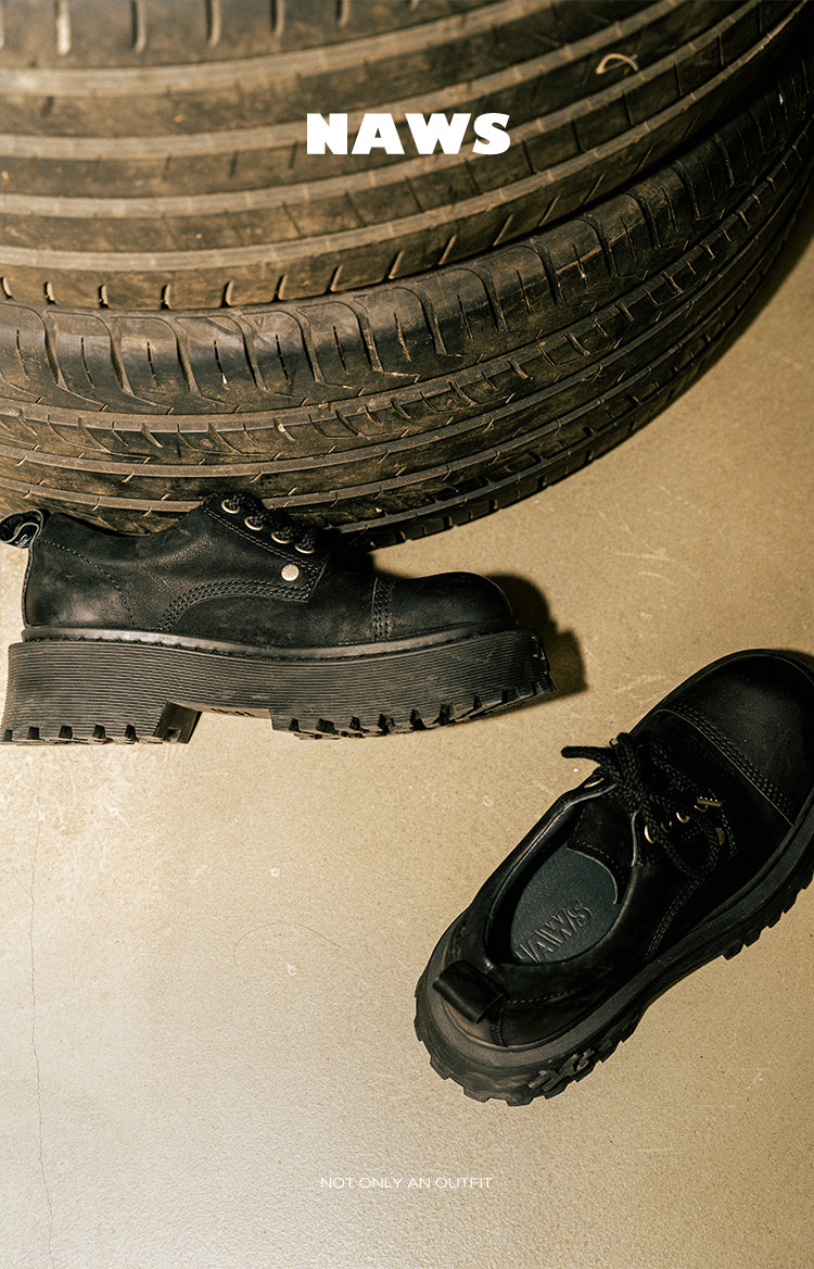 NAWS MOORE matte leather platform Derby shoes in MOORE BLACK — outdoor styled view of black platform Derby shoes beside a vehicle tire.