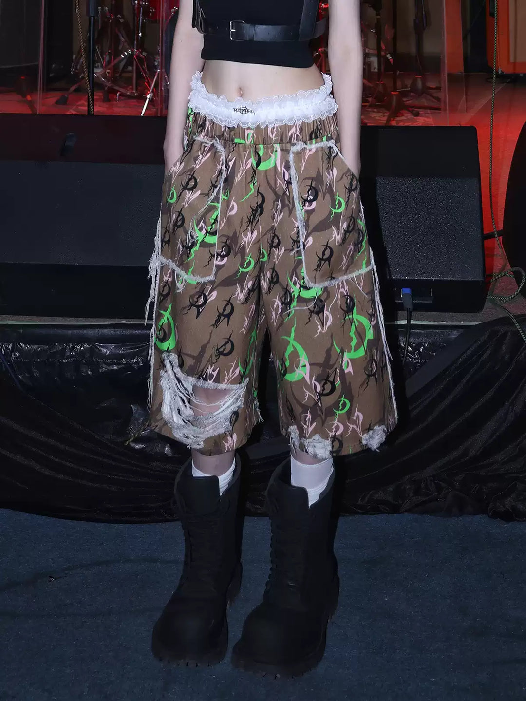 PINKSPINK ELECTRIC MOON distressed camo cropped trousers in CAMOUFLAGE — close front hero showing frayed patch pockets and shredded legs.
