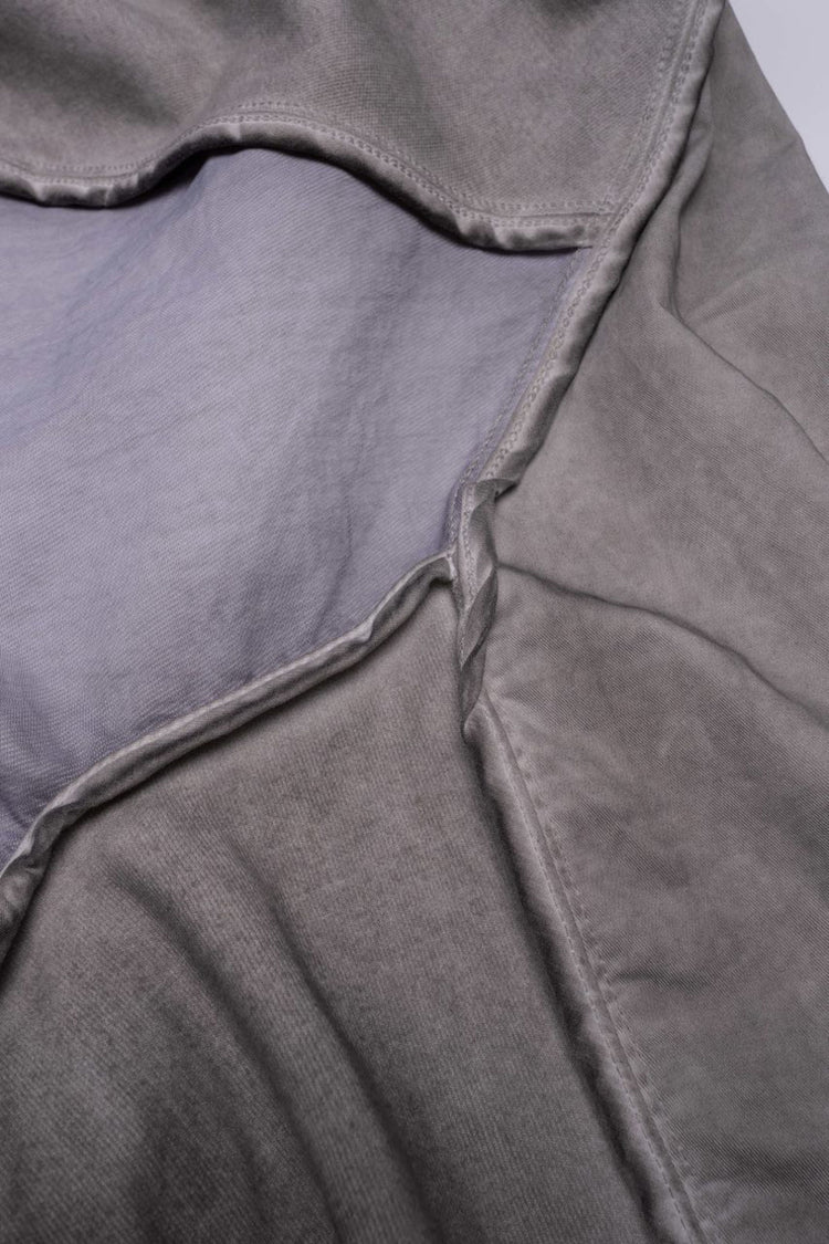 PIONEER eris white detachable-pocket utility hoodie — close-up of the contrast fabric panel and finished curved seams