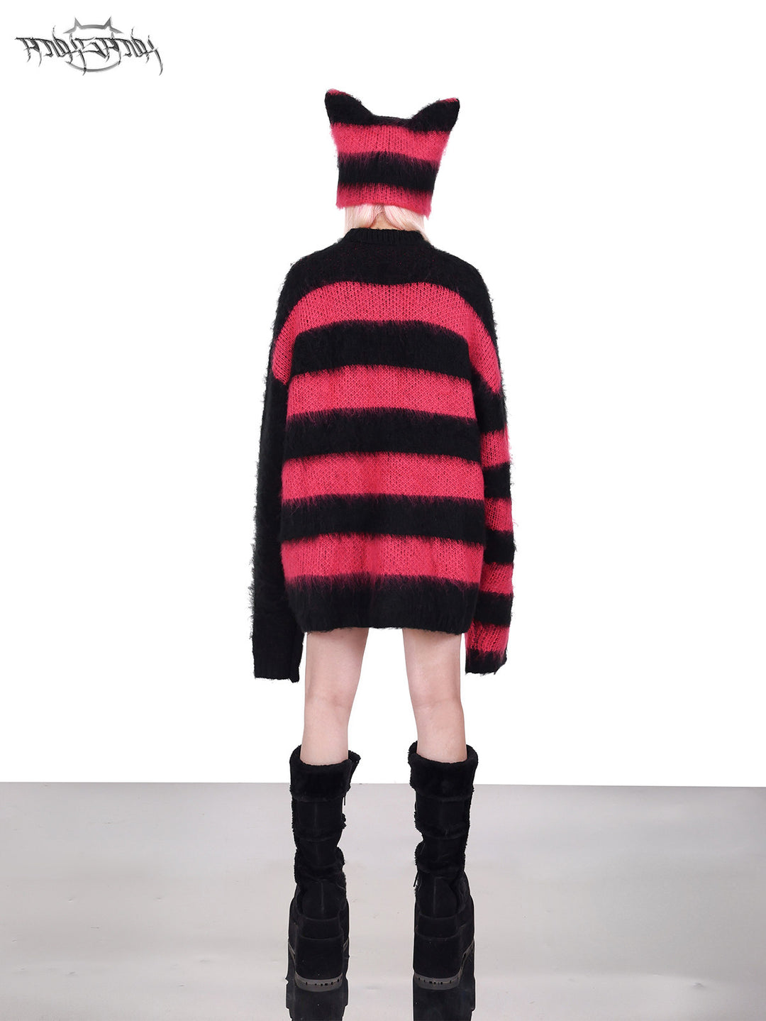 PINKSPINK SPHYNX striped cat-ear knit hat in black pink — side modeled close-up showing the striped knit and pointed ear