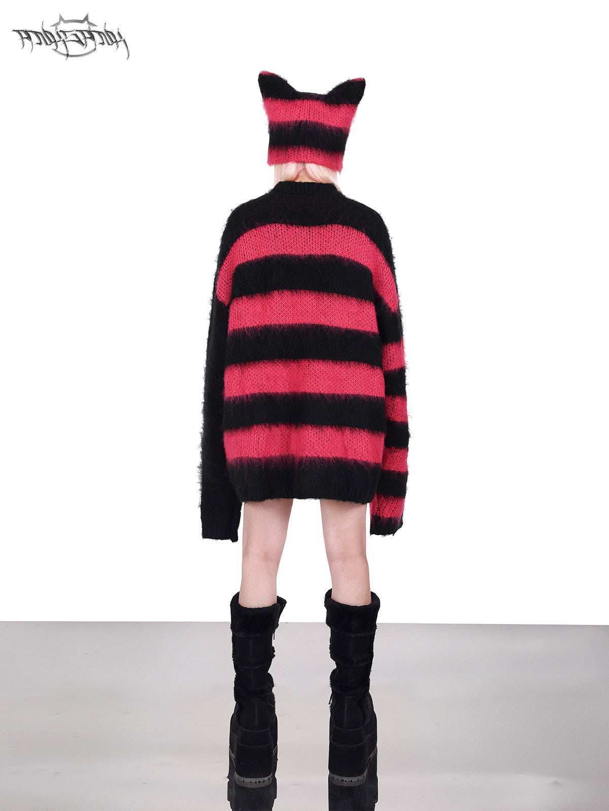 PINKSPINK SPHYNX striped cat-ear knit hat in black pink — side modeled close-up showing the striped knit and pointed ear