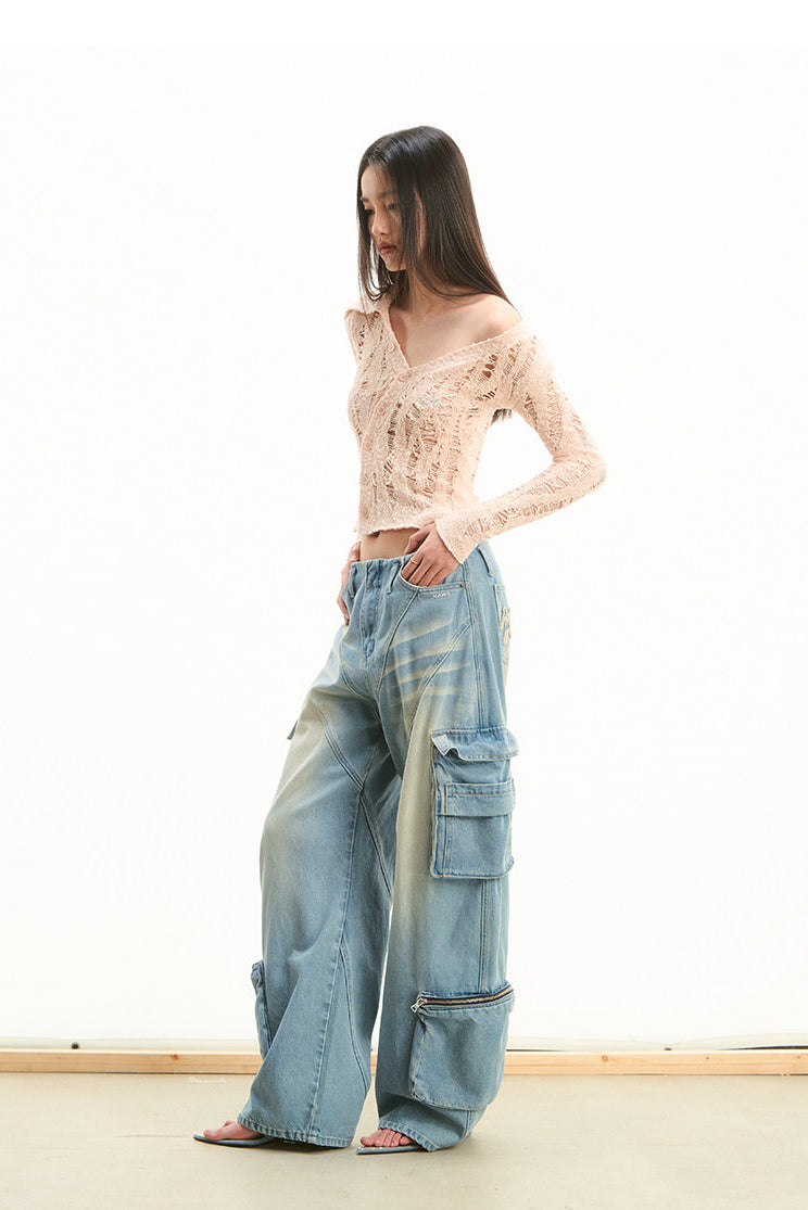NAWS NOMAD asymmetric cutout knit cardigan — modeled detail view of the garment construction