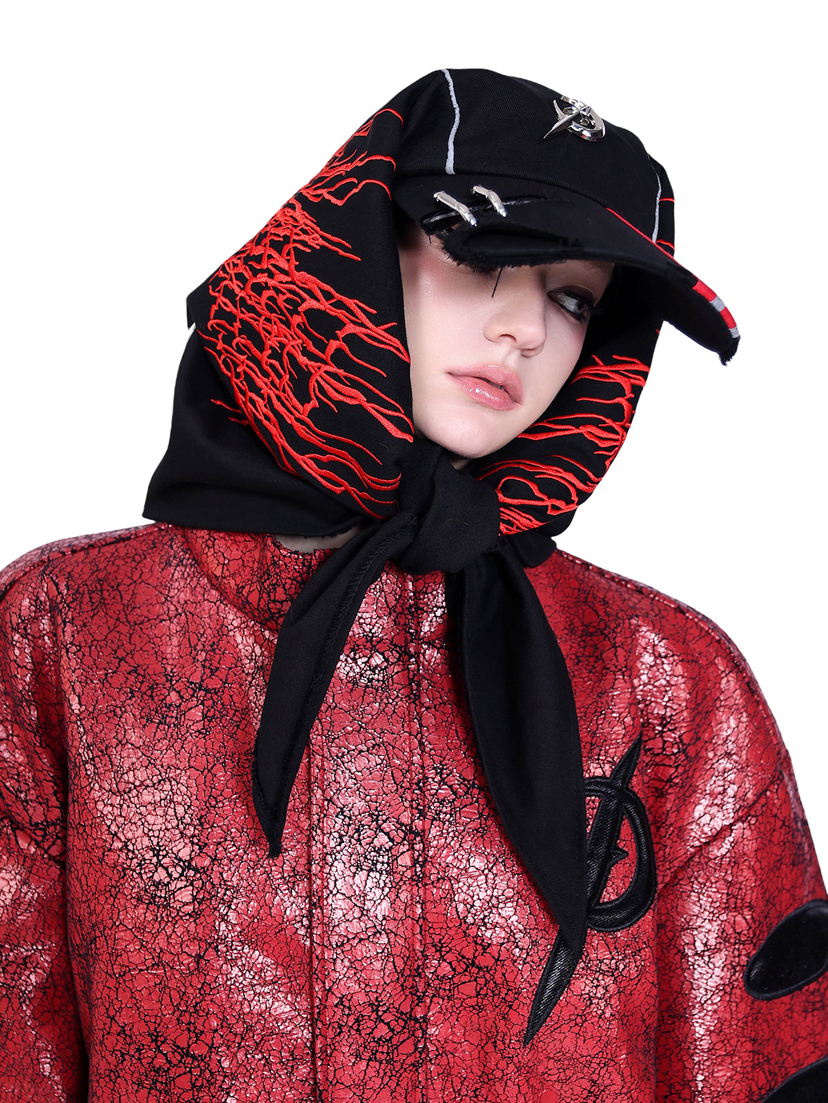 PINKSPINK ELECTRIC MOON cracked faux-leather moto jacket — Angled close-up of red crackled chest panels and collar