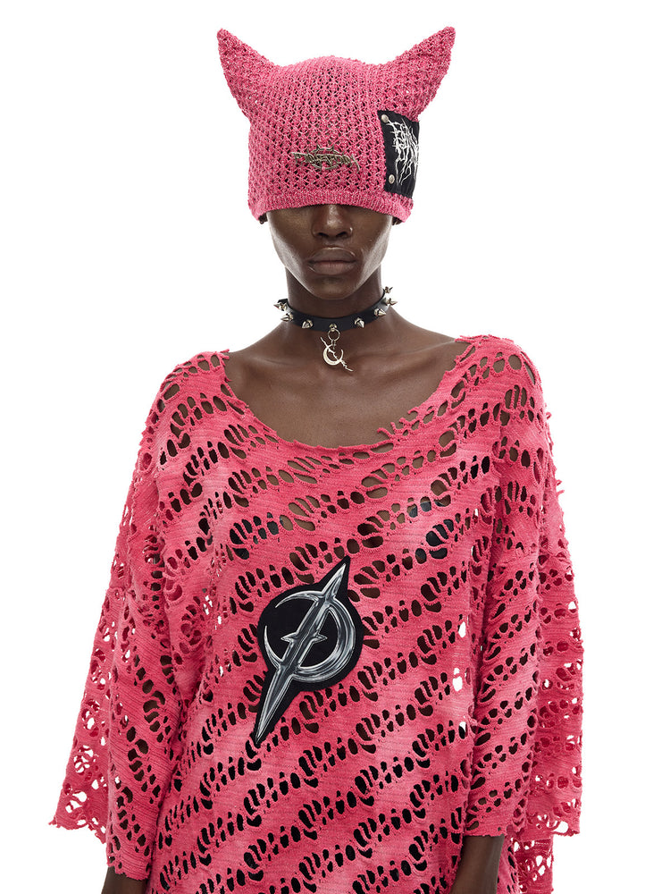 PINKSPINK ELECTRIC MOON distressed open-knit oversized tee in pink — close front modeled view with a cat-ear beanie