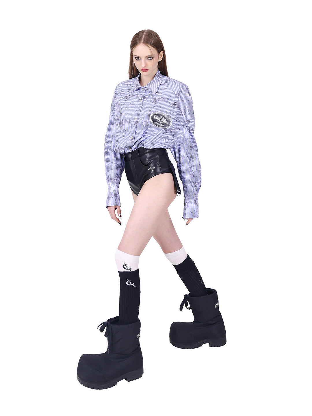 PINKSPINK REBEL ring-pierced faux-leather hotpants in black — angled side modeled view highlighting the high-cut leg