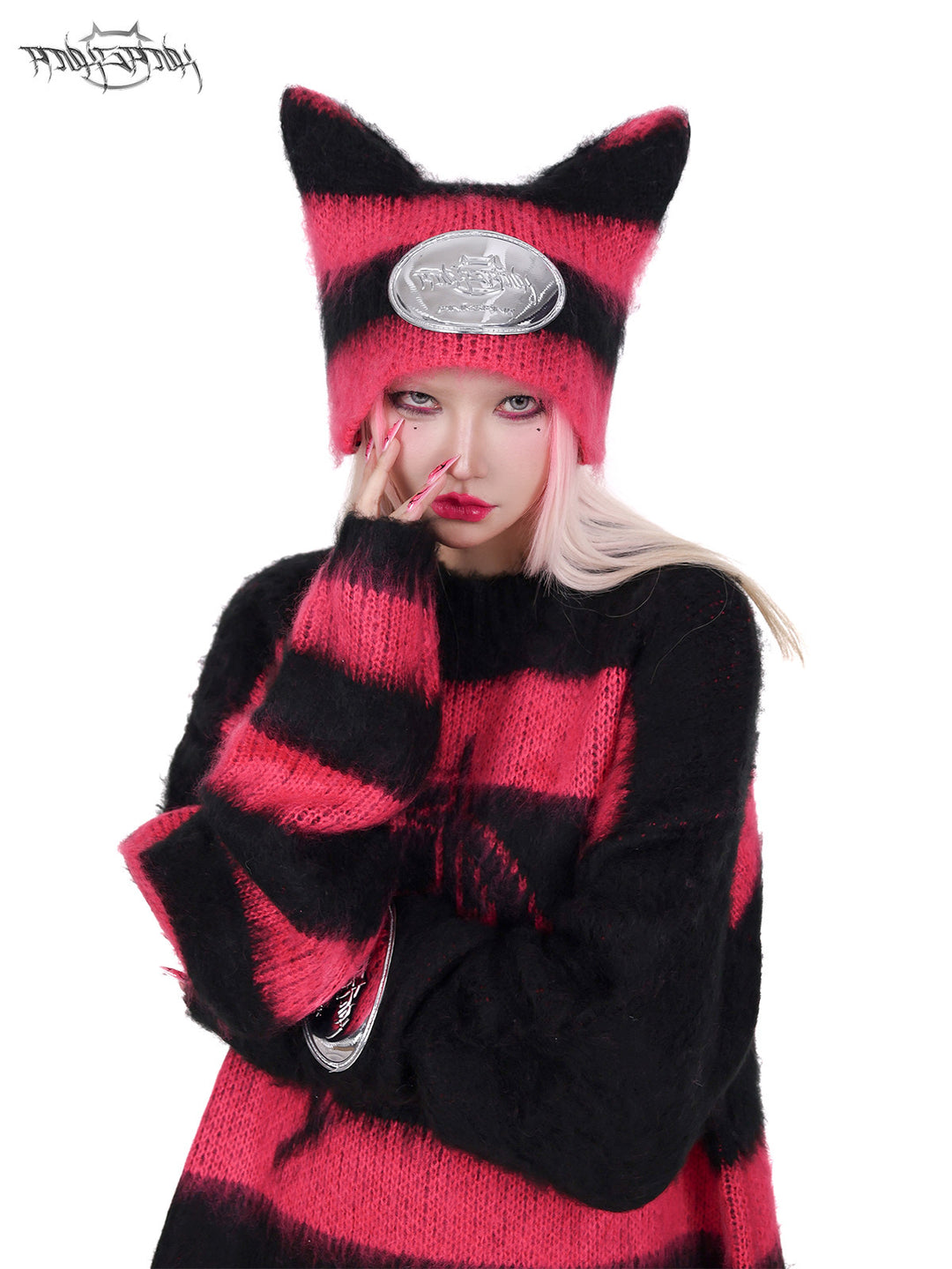 PINKSPINK SPHYNX striped cat-ear knit hat in black pink — front modeled close-up corresponding to the hero image