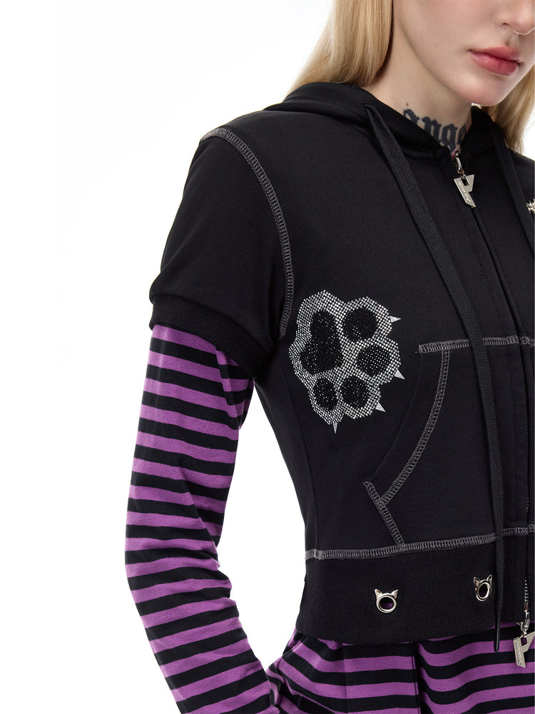 PINKSPINK CATPAW cropped cat-ear zip hoodie in black — close-up of the paw motif and shoulder seams over a separate striped layer