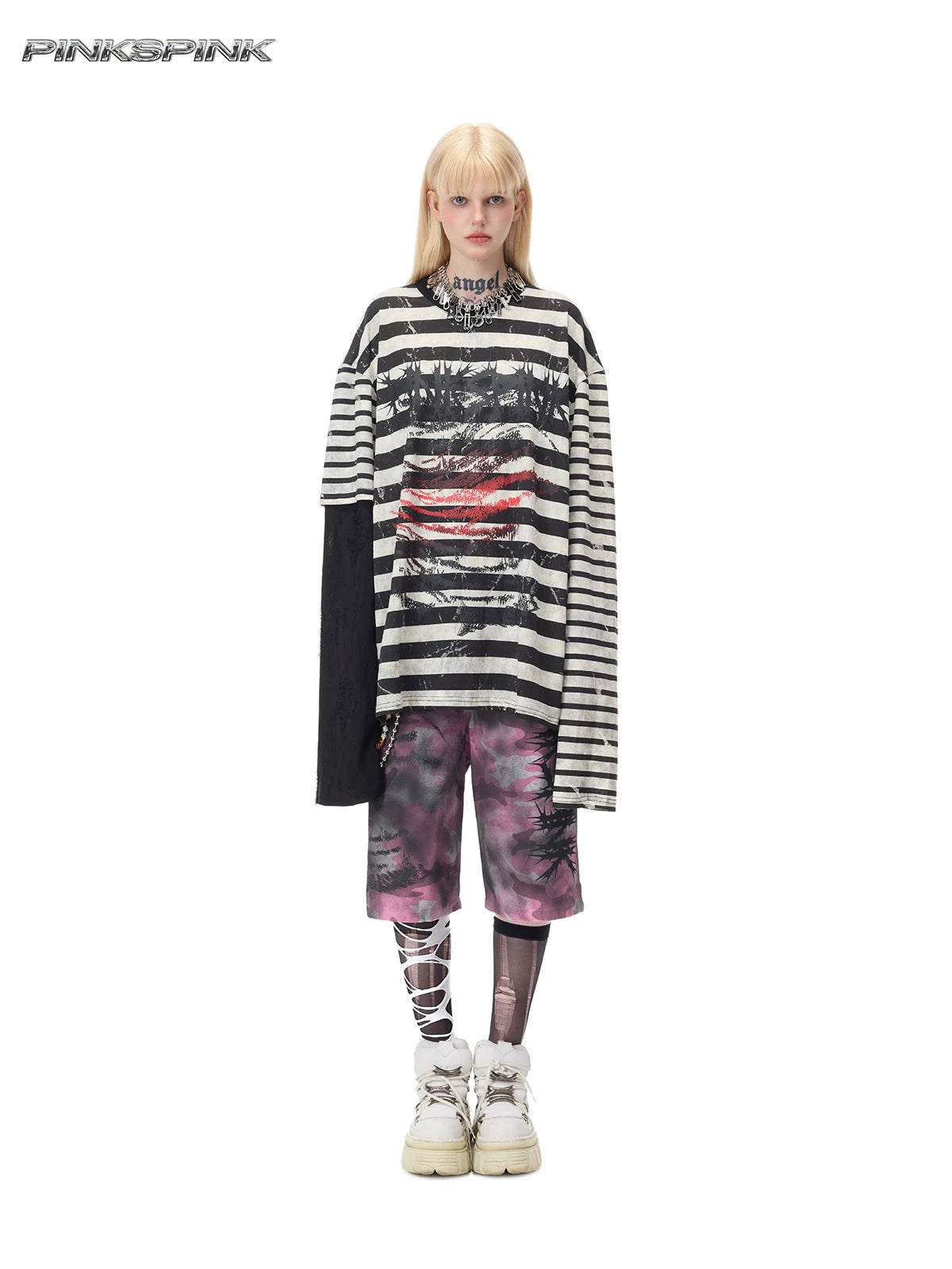 PINKSPINK STATIC asymmetric striped burnout long-sleeve tee in black and white — full-length front modeled view over separate pink camouflage shorts