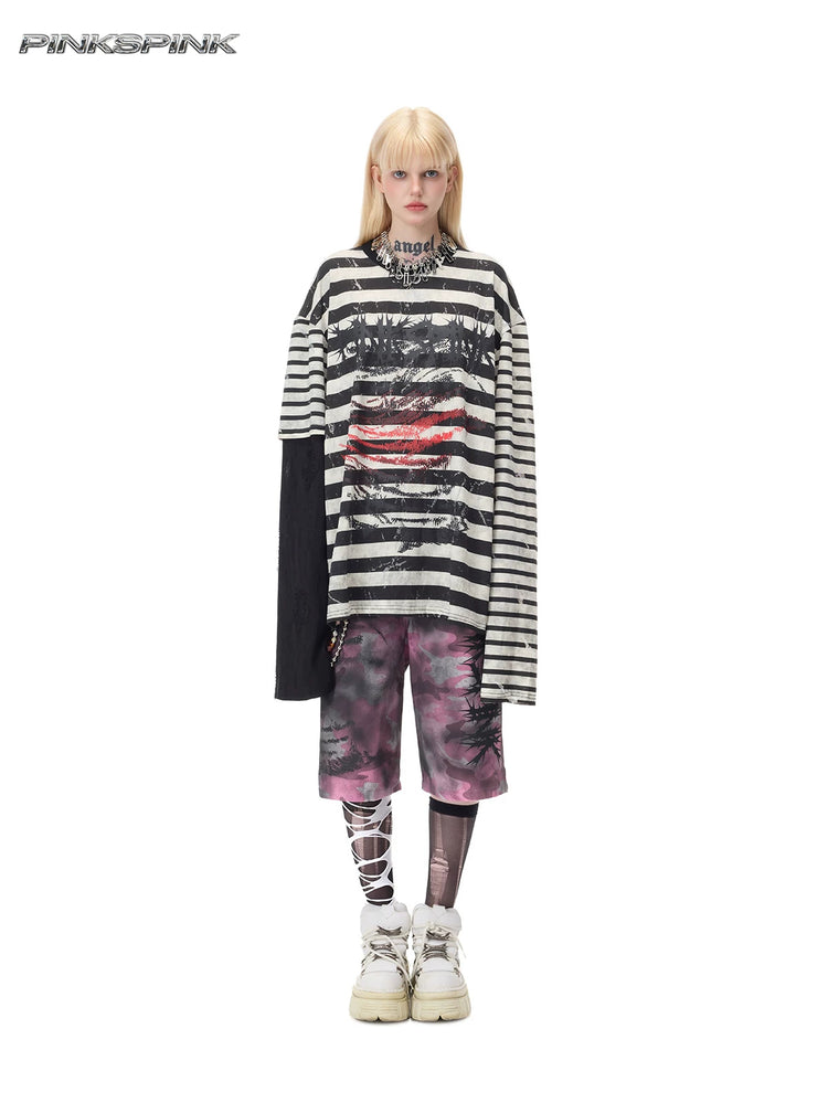 PINKSPINK STATIC asymmetric striped burnout long-sleeve tee in black and white — full-length front modeled view over separate pink camouflage shorts