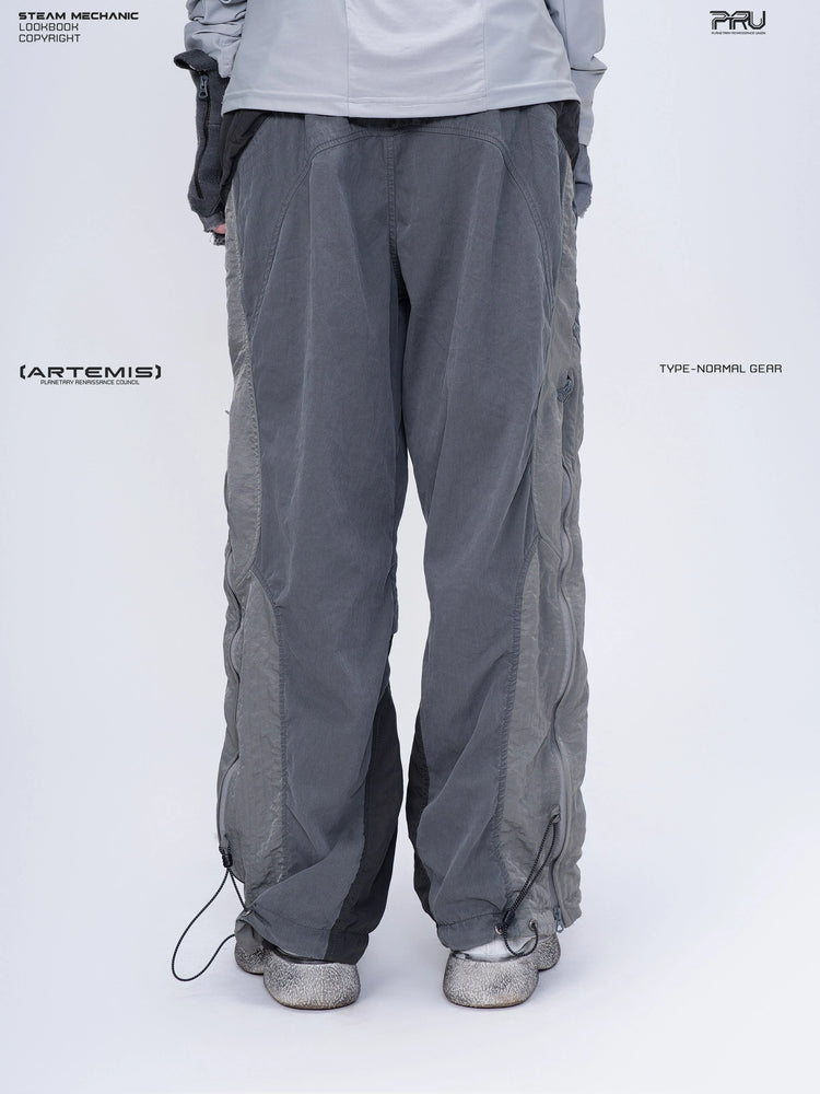 SUPERNOVA alloy gray metallic nylon technical pants — rear modeled close-up showing adjustable hems
