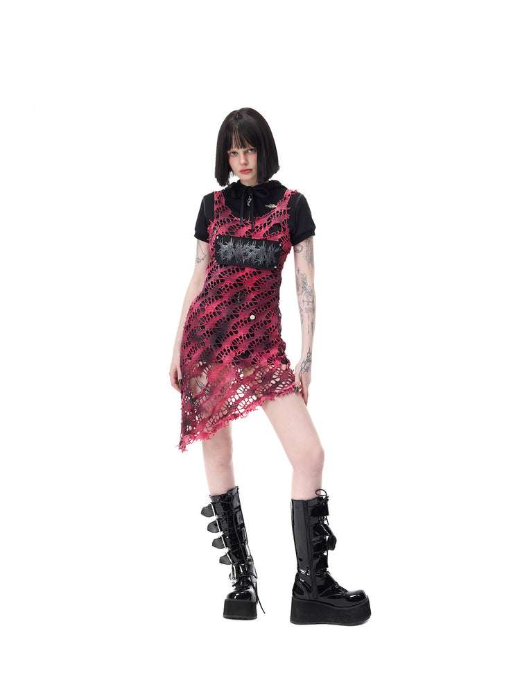 PINKSPINK AFTERGLOW distressed open-knit asymmetric dress in hot pink — angled full-length front modeled view with the sheer hem extending over separate black shorts
