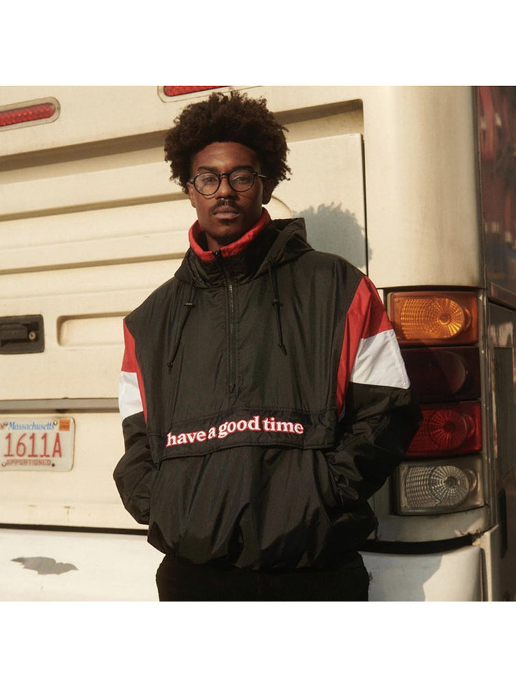 HAVE A GOOD TIME ANORAK padded pullover worn by a model in front of a bus, showing its relaxed front silhouette