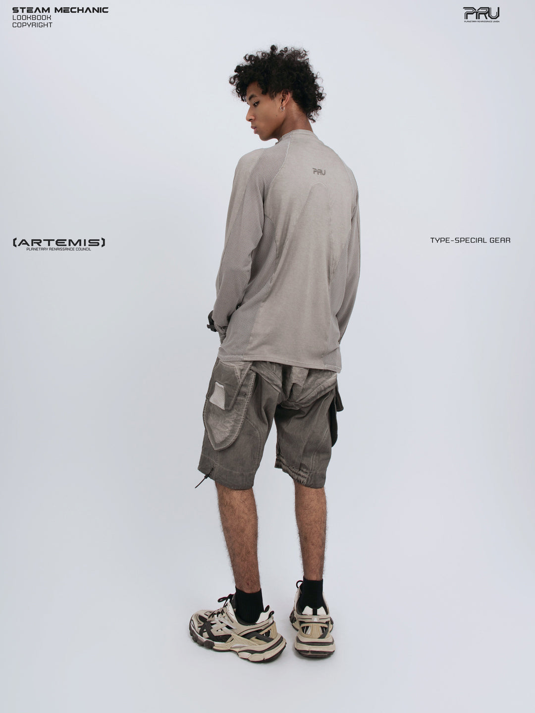 STARCORE mesh-panel long-sleeve top — full-length opposite rear three-quarter view
