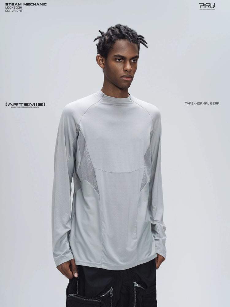 ARTEMIS moon dust gray stretch technical base-layer top — three-quarter modeled view showing the raglan shoulder and fitted sleeve